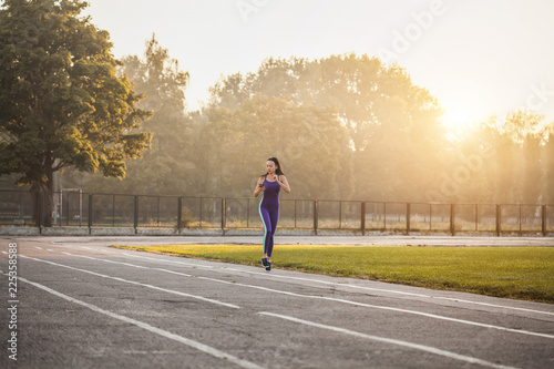 Woman athlete on a morning run in the stadium. Active lifestyle