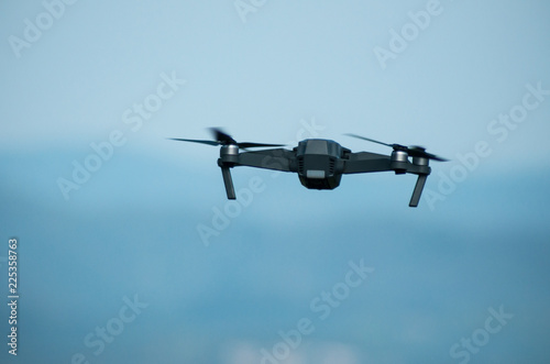 Fototapeta Naklejka Na Ścianę i Meble -  closeup of small drone for video appllcation in outdoor on blue sky background