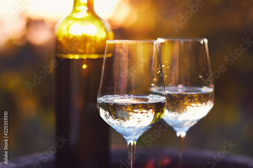 Two glasses of white wine at sunset
