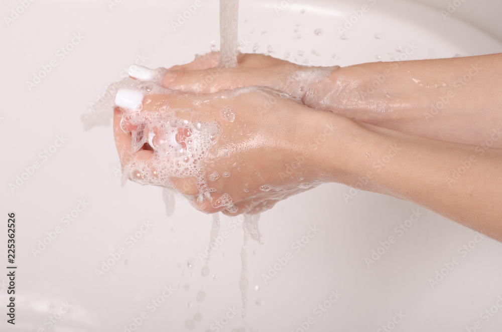 Fototapeta premium Soapy hands water faucet bathroom disinfection care