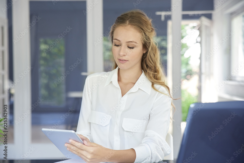 Businesswoman with digital tablet in the office Businesswoman with digital tablet in the office