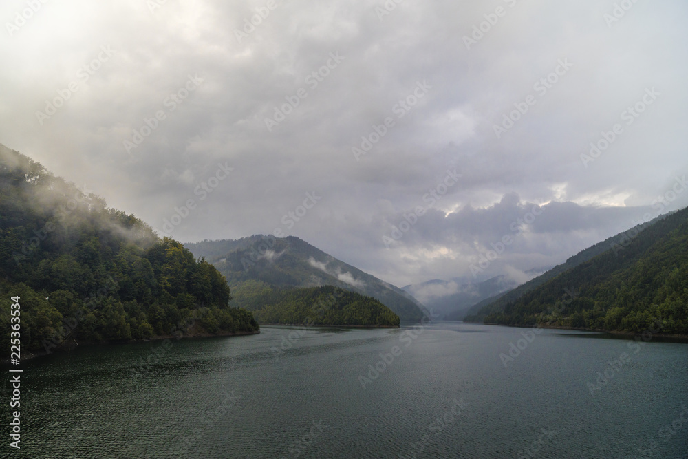 mountain lake, dam, rain clouds and noise