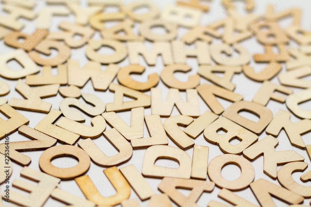 Surface covered with multiple wooden letters as a background composition, isolated Surface covered with multiple wooden letters as a background composition, isolated
