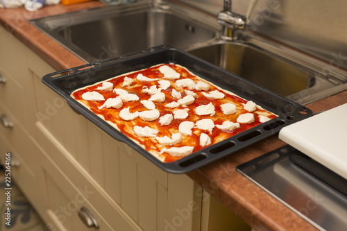 image of pizza pans prepared before being baked