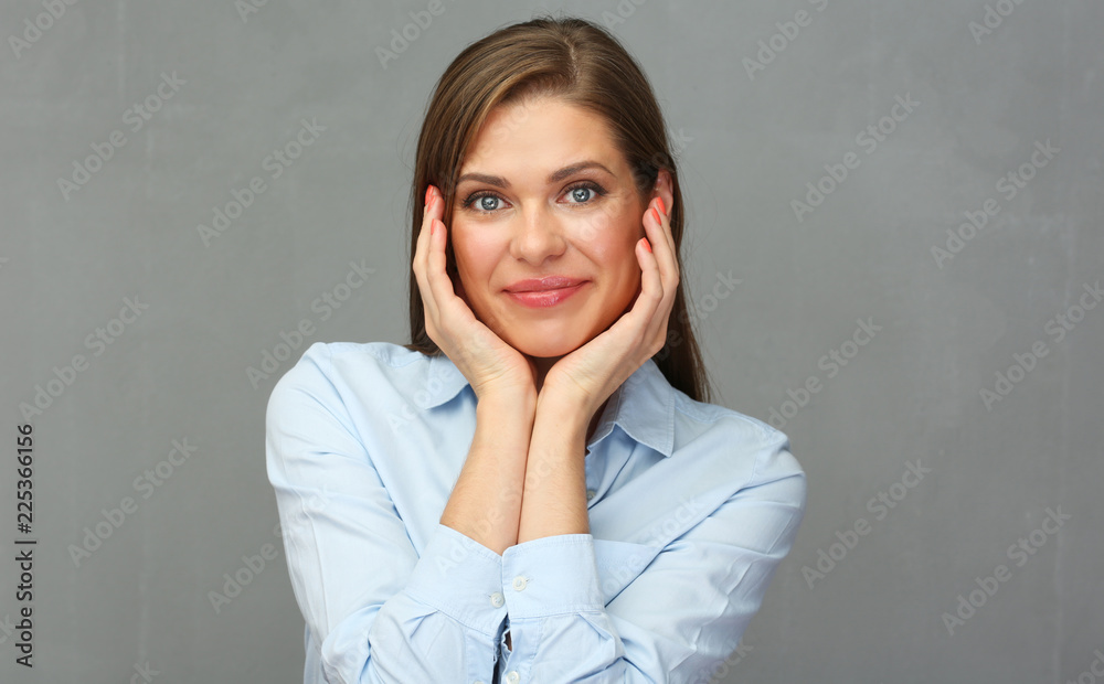 Fototapeta premium Close up portrait of smiling woman with arms. Grey wall background.