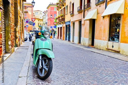 View of a classic Italian scooter on the historic street in Vicenza, Italy.