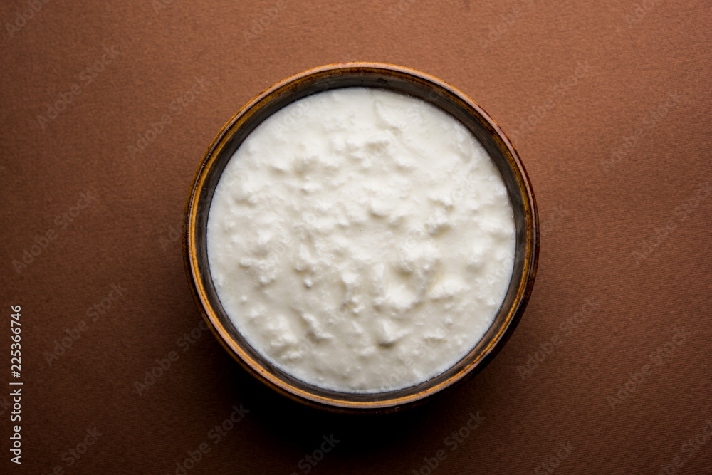 Plain curd or yogurt or Dahi in Hindi, served in a bowl over moody background. Selective focus Plain curd or yogurt or Dahi in Hindi, served in a bowl over moody background. Selective focus