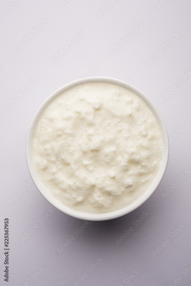 Plain curd or yogurt or Dahi in Hindi, served in a bowl over moody background. Selective focus Plain curd or yogurt or Dahi in Hindi, served in a bowl over moody background. Selective focus