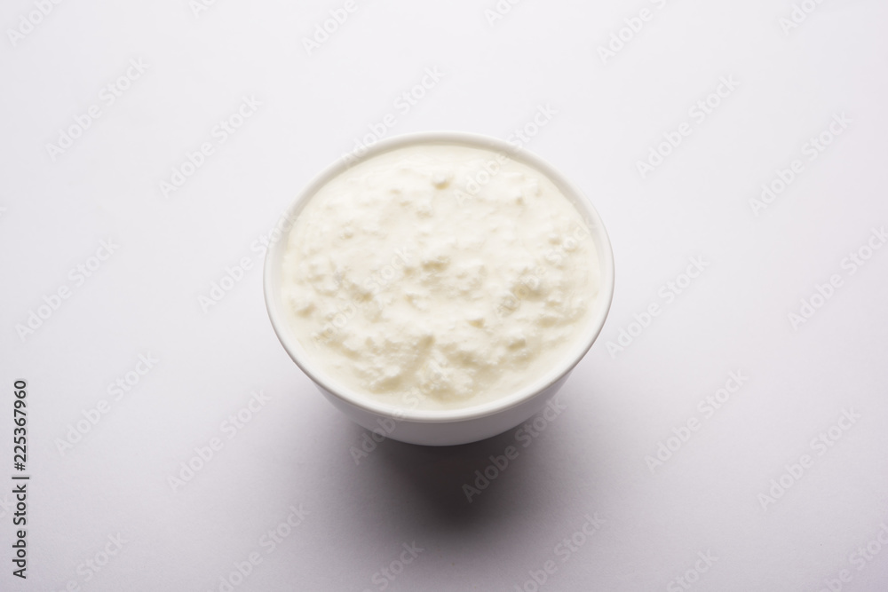Plain curd or yogurt or Dahi in Hindi, served in a bowl over moody background. Selective focus Plain curd or yogurt or Dahi in Hindi, served in a bowl over moody background. Selective focus