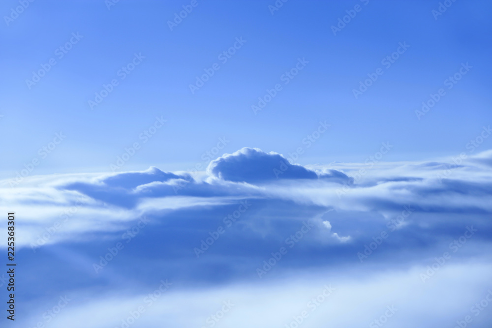 Wonderful panorama from window of plane with white clouds