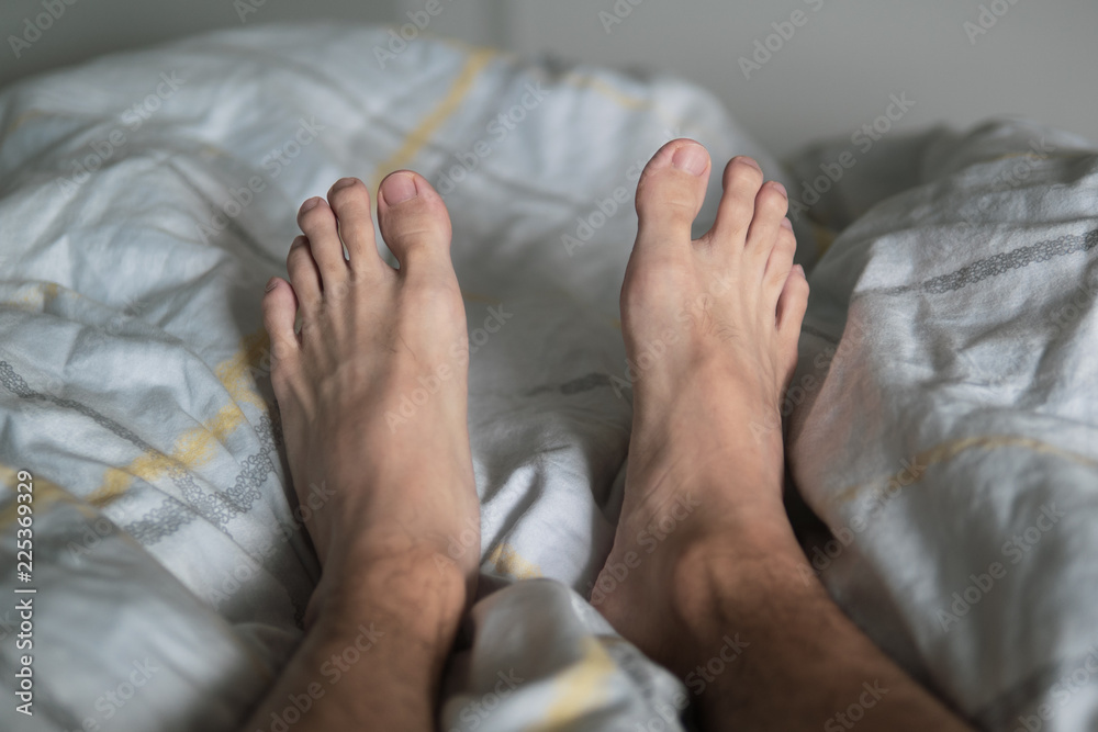 Men legs on the bed Stock Photo | Adobe Stock