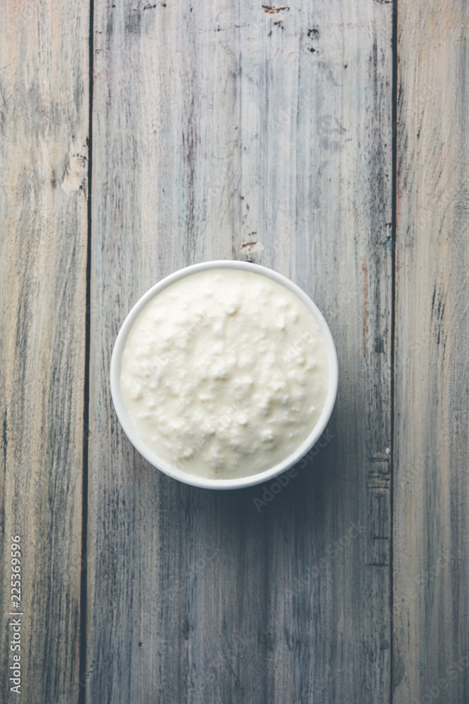 Plain curd or yogurt or Dahi in Hindi, served in a bowl over moody background. Selective focus Plain curd or yogurt or Dahi in Hindi, served in a bowl over moody background. Selective focus