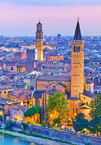 View of the historic city center along Adige river at dusk in Verona, Italy.