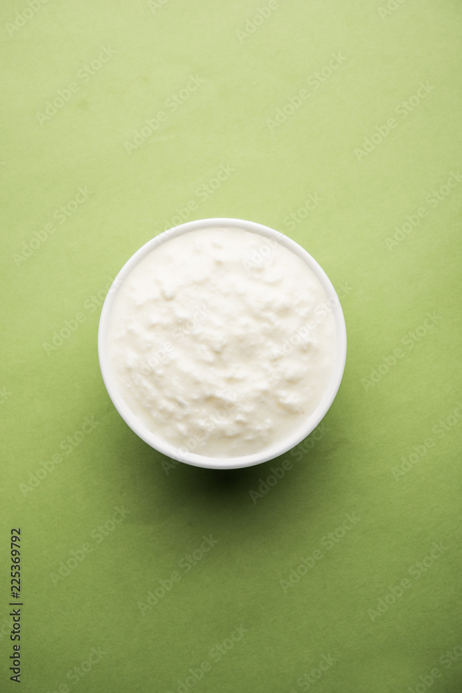 Plain curd or yogurt or Dahi in Hindi, served in a bowl over moody background. Selective focus Plain curd or yogurt or Dahi in Hindi, served in a bowl over moody background. Selective focus