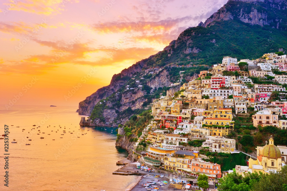 View of Positano village along Amalfi Coast in Italy at sunset.