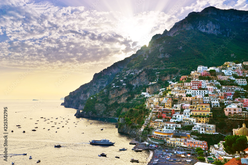 View of Positano village along Amalfi Coast in Italy at sunset.