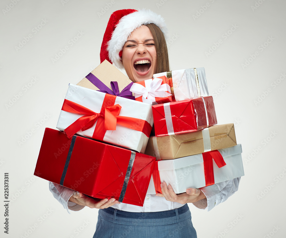 Happy woman wearing santa hat holding pile of gifts. Happy woman wearing santa hat holding pile of gifts.