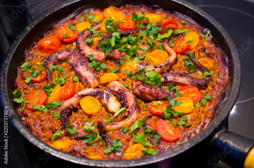 Paella with octopus on the pan
