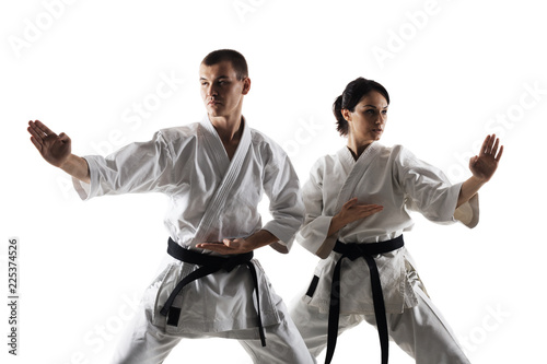 karate girl and boy posing against white background
