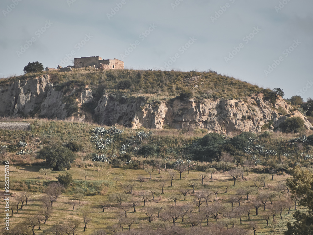  Shot of a rural landscape with an house on top of an hill