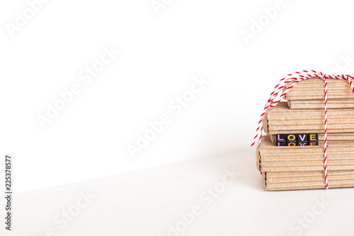 Stack of handcraft gift boxes on white wooden background with text Love of colored cubes. copy space  place for text. Romantic wallpaper and background