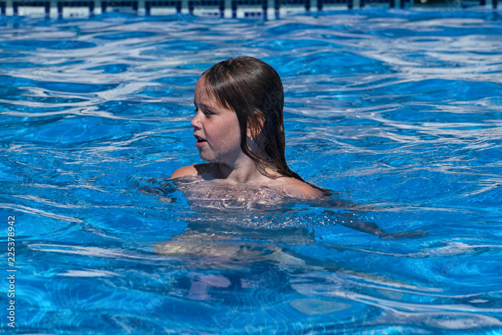 Small girl in the swimming pool.
