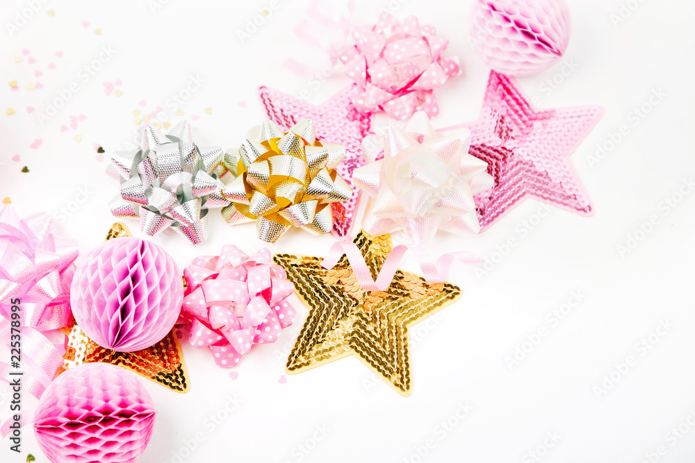 Pastel Pink confetti, bows and paper decorations. Flat lay, top view. Holiday composition for birthday party, New year/Christmas celebration or hen party concept theme. Flat lay, top view Pastel Pink confetti, bows and paper decorations. Flat lay, top view. Holiday composition for birthday party, New year/Christmas celebration or hen party concept theme. Flat lay, top view
