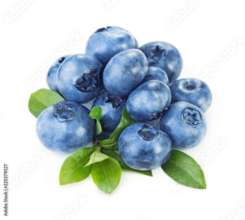 heap of ripe blueberry with leaves isolated on white background
