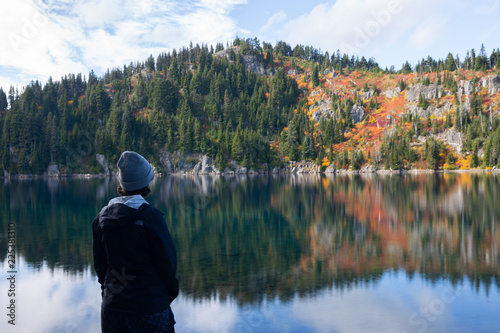 Woman observing nature at a Pacific Northwest lake in fall 