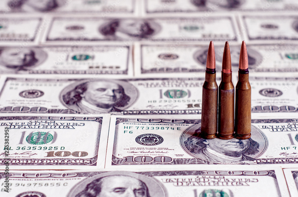 Abstract image of bullets for military weapons as a symbol of terrorism on a red background (economic sanctions - a concept)м