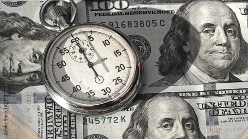 Abstract image of stopwatch and dollar notes (sanctions, success, time is money - concept)