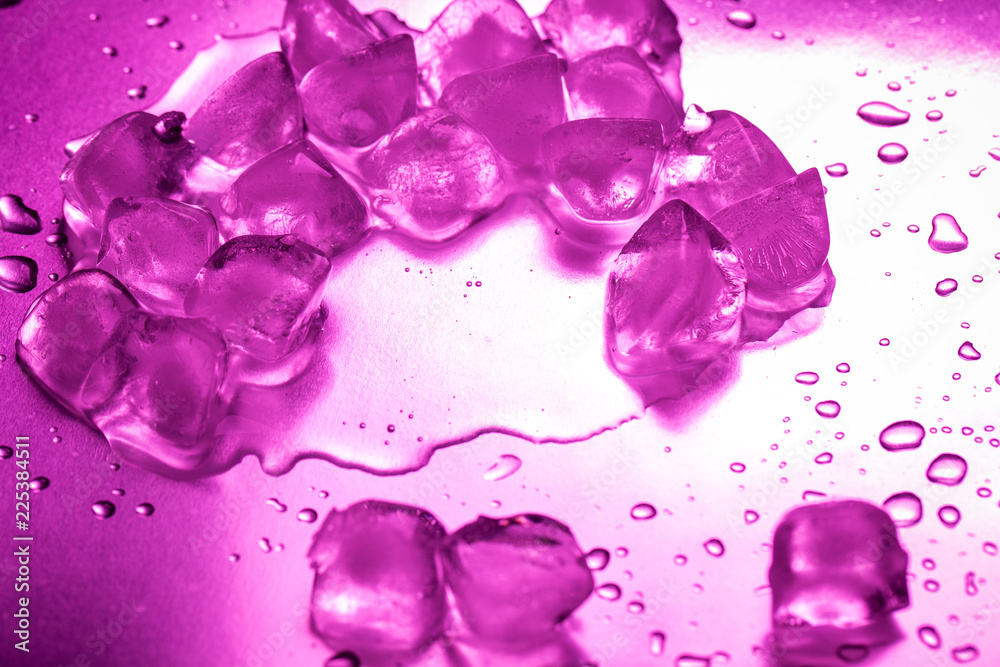 A pile of ice cubes in purple on a reflecting table A pile of ice cubes in purple on a reflecting table