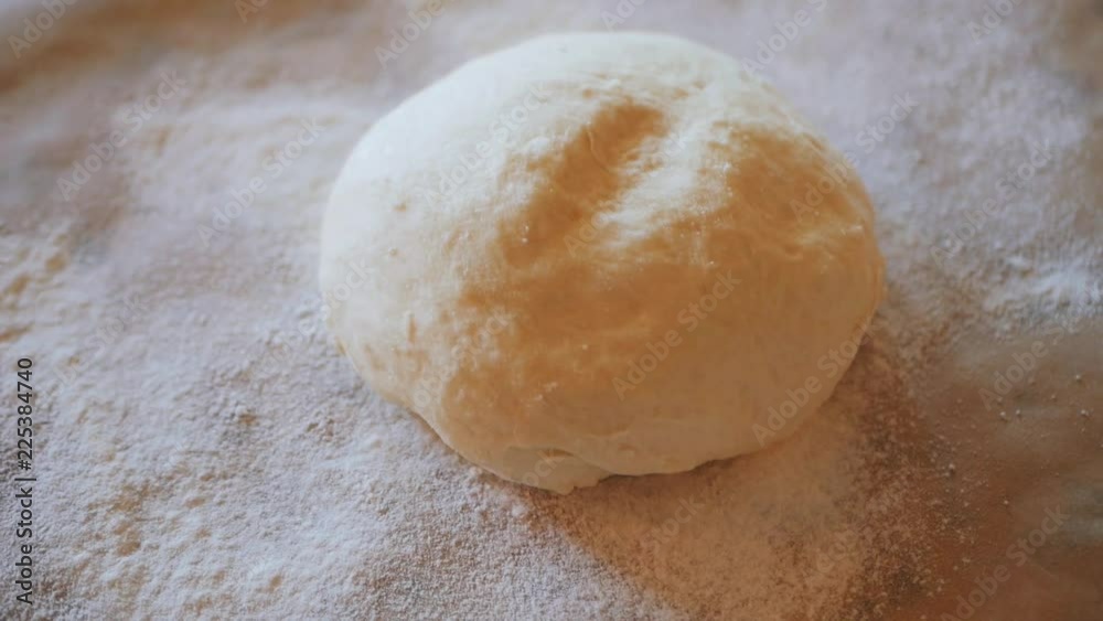 Fresh raw pizza or bread dough is on the table Fresh raw pizza or bread dough is on the table