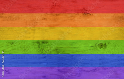 LGBT flag colors over wooden textured background. Gay pride