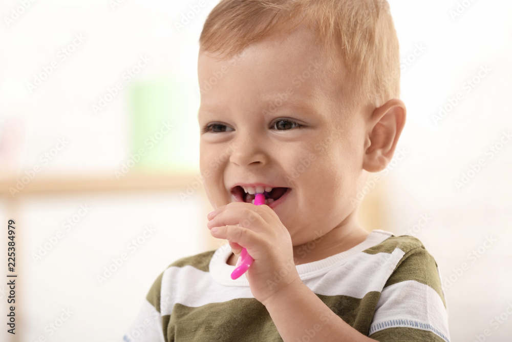 Cute little boy with toothbrush on blurred background Cute little boy with toothbrush on blurred background