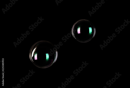 Beautiful translucent soap bubbles on dark background. Space for text