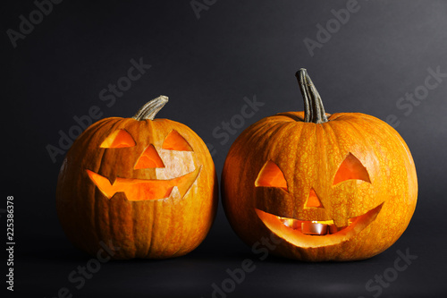 Halloween pumpkin head jack lanterns on dark background