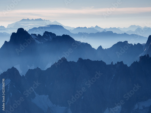 Early morning Alpine landscape with rows of steep peaks © merial