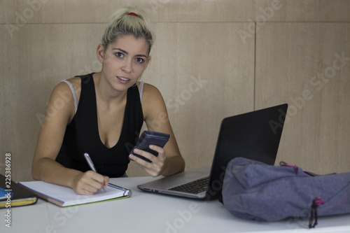 pretty young student girl with calculator photo