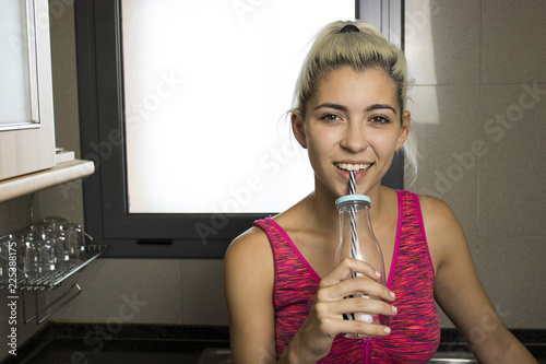 Young girl drinking by a straw photo