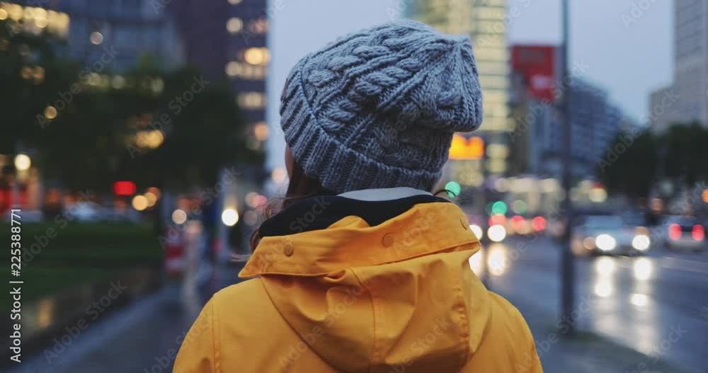 Portrait of Woman Standing on the Wind in Big City. SLOW MOTION 4K. Young Woman in Berlin waiting near the busy road. Breeze is playing with girls hair. Stormy weather, autumn, winter, spring. Portrait of Woman Standing on the Wind in Big City. SLOW MOTION 4K. Young Woman in Berlin waiting near the busy road. Breeze is playing with girls hair. Stormy weather, autumn, winter, spring.