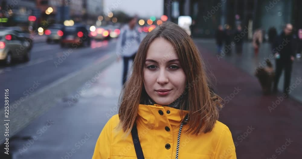 Portrait of Woman Standing on the Wind in Big City. SLOW MOTION 4K. Young Woman in Berlin waiting near the busy road. Breeze is playing with girls hair. Stormy weather, autumn, winter, spring. Portrait of Woman Standing on the Wind in Big City. SLOW MOTION 4K. Young Woman in Berlin waiting near the busy road. Breeze is playing with girls hair. Stormy weather, autumn, winter, spring.