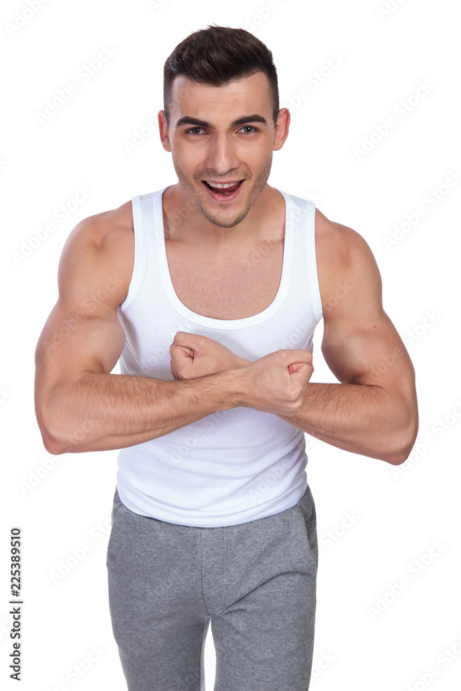 portrait of excited man in undershirt flexing his hands portrait of excited man in undershirt flexing his hands