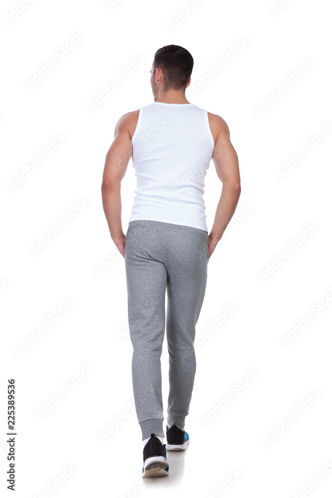 rear view of relaxed man walking and looking to side rear view of relaxed man walking and looking to side