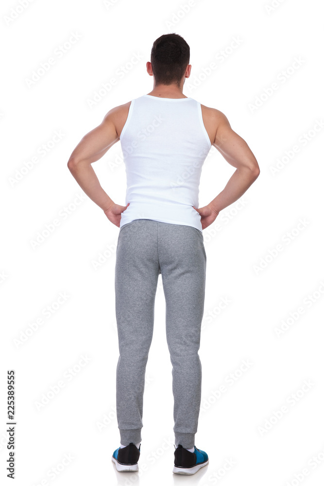 back view of confident muscular man in undershirt standing back view of confident muscular man in undershirt standing