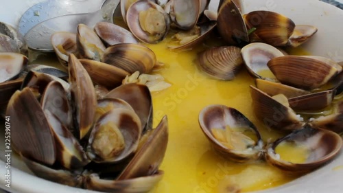 Woman eating clams with hands