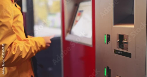 Woman Buying Train Ticket in Ticket Vending Machine on a Station. SLOW MOTION 4K. Unrecogbizable Girl uses smart city technology to get a transport ticket for a bus, train or subway. 