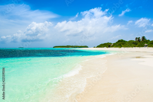 Fototapeta Naklejka Na Ścianę i Meble -  Beautiful sandy beach with sunbeds and umbrellas in Indian ocean, Maldives island