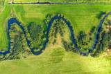 Aerial view on winding river in rural landscape