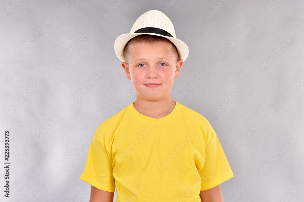The boy in the hat. A young man in a yellow T-shirt. The boy in the hat. A young man in a yellow T-shirt.